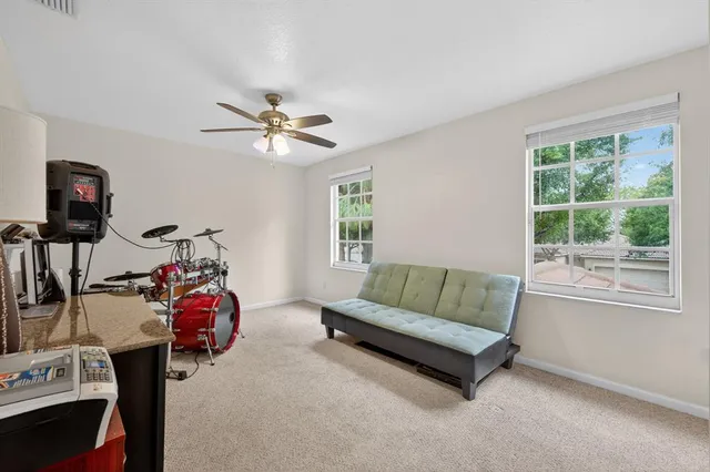 a living room with furniture fireplace and a window
