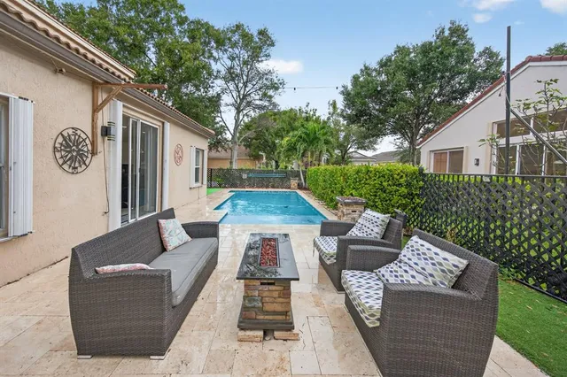 a view of backyard of house with seating space