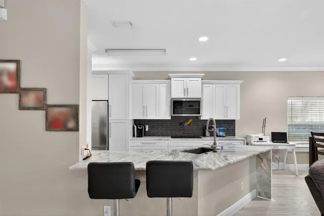 a kitchen with stainless steel appliances kitchen island granite countertop a sink and cabinets