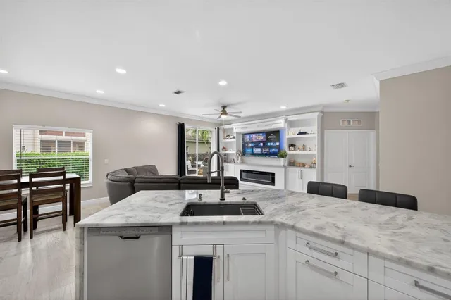 a kitchen with granite countertop a sink and a stove