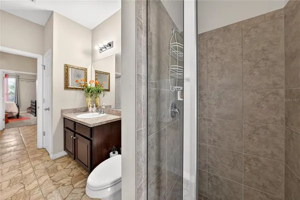 a bedroom with a bed and a painting on the wall