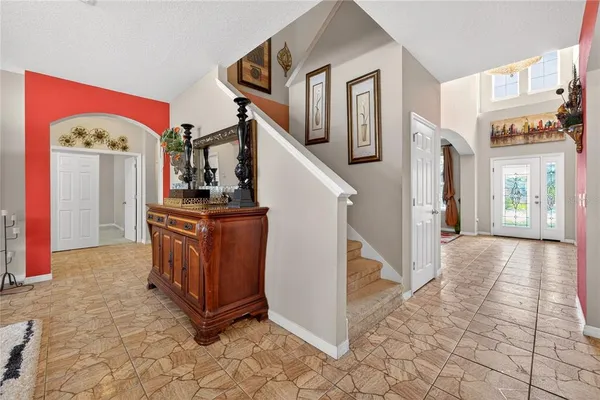a bedroom with a bed and dresser with mirror