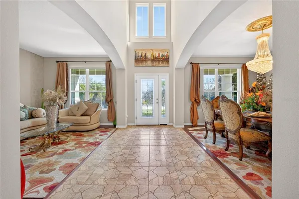 a living room with furniture and a floor to ceiling window