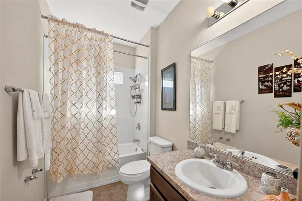 a spacious bathroom with a tub sink and mirror