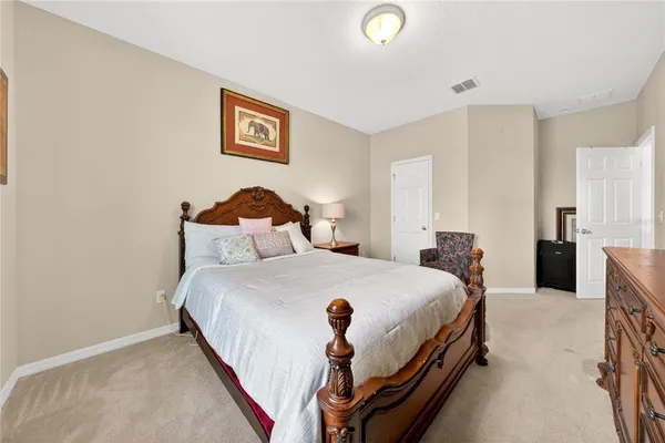 a bedroom with furniture and a closet