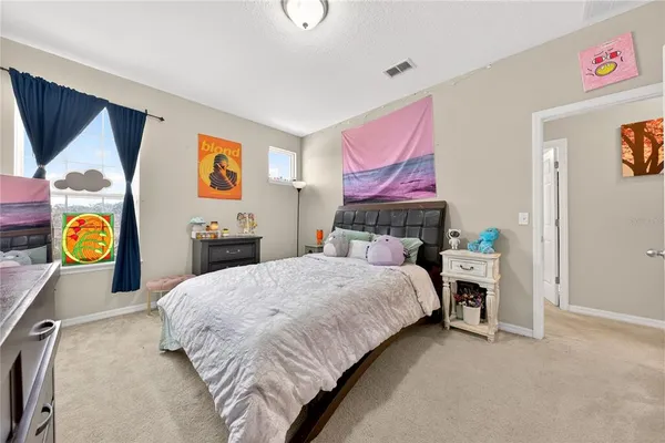 a bedroom with a bed and a dresser