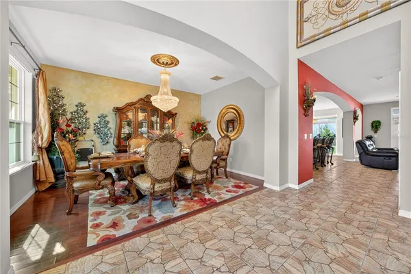 a view of a dining room with furniture and a chandelier