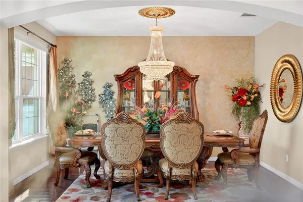 a living room with furniture and a mirror