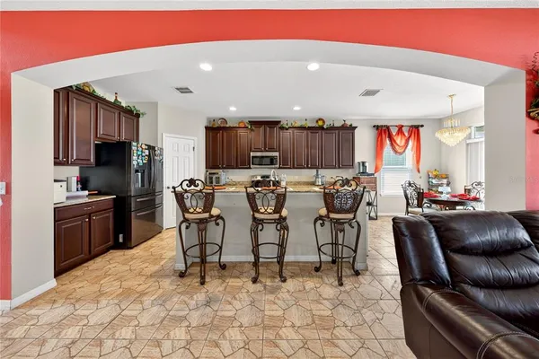 a kitchen with granite countertop a sink and a large mirror