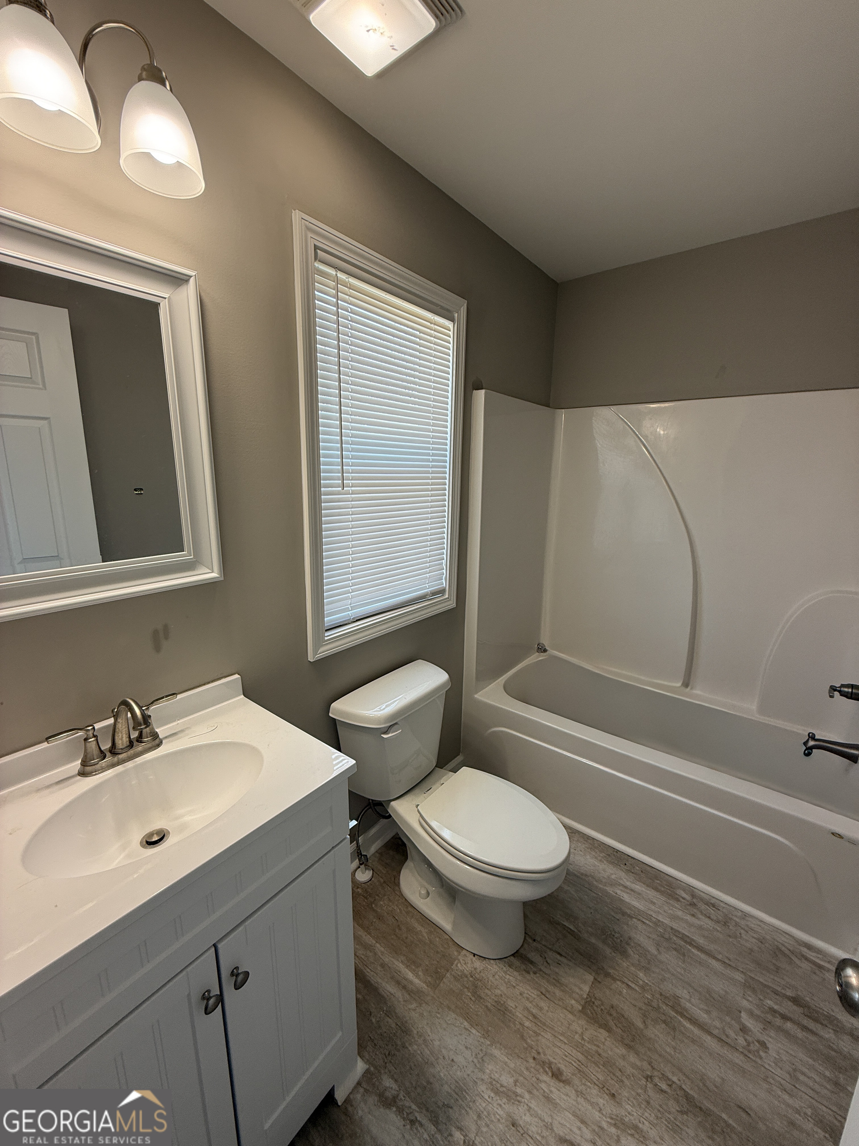 305 Martin Circle Athens, GA 30601 - Photo 13 of 15 a bathroom with a sink a toilet and a mirror
