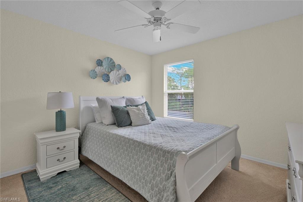 386 Emerald Bay Circle, Unit G4 Naples, FL 34110 - Photo 12 of 20 a bedroom with a bed and a window