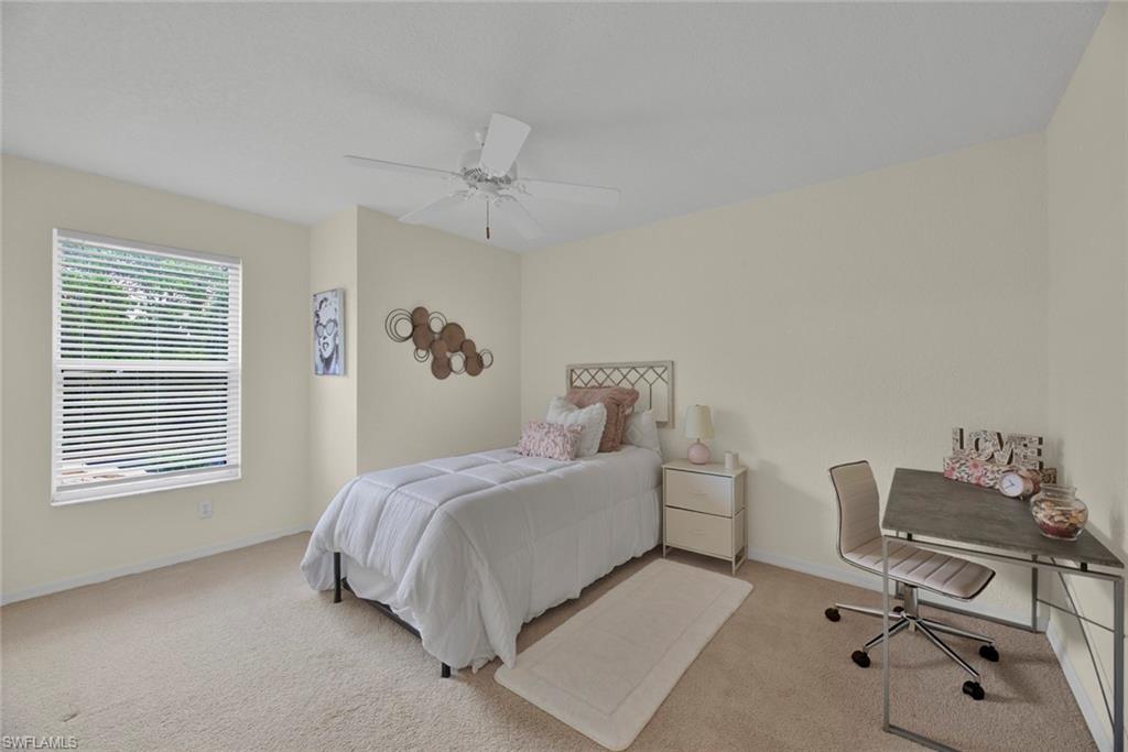 386 Emerald Bay Circle, Unit G4 Naples, FL 34110 - Photo 14 of 20 a bed room with a bed window and a chair