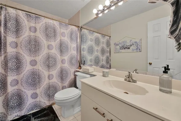a bathroom with a sink mirror vanity and toilet