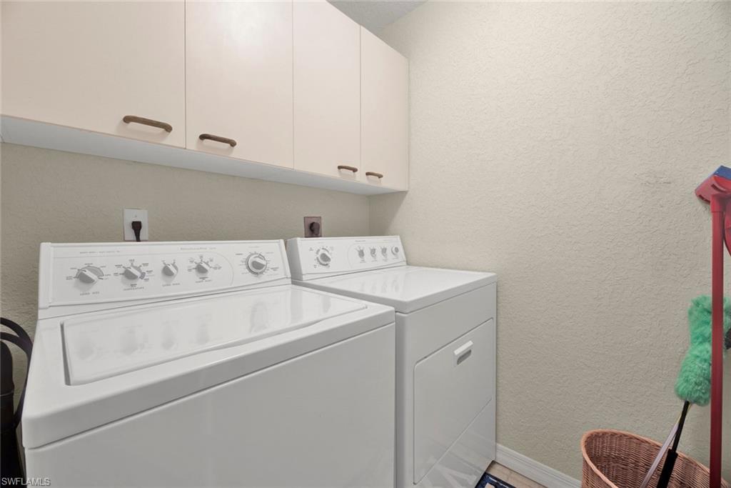 386 Emerald Bay Circle, Unit G4 Naples, FL 34110 - Photo 16 of 20 a utility room with dryer and washer