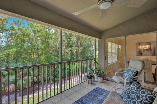 a balcony with furniture and wooden floor
