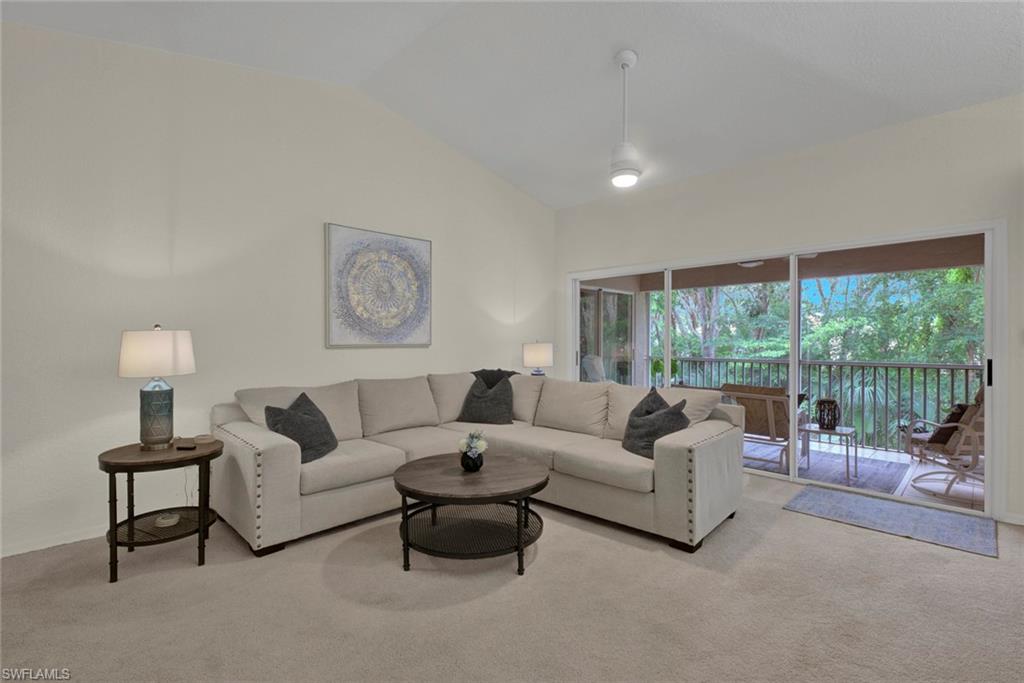 386 Emerald Bay Circle, Unit G4 Naples, FL 34110 - Photo 3 of 20 a living room with furniture and a large window