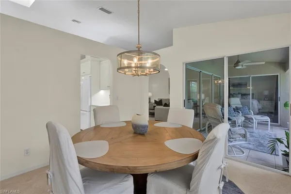 a dining room with furniture and chandelier