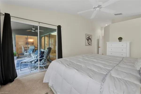 a bedroom with a bed and large windows