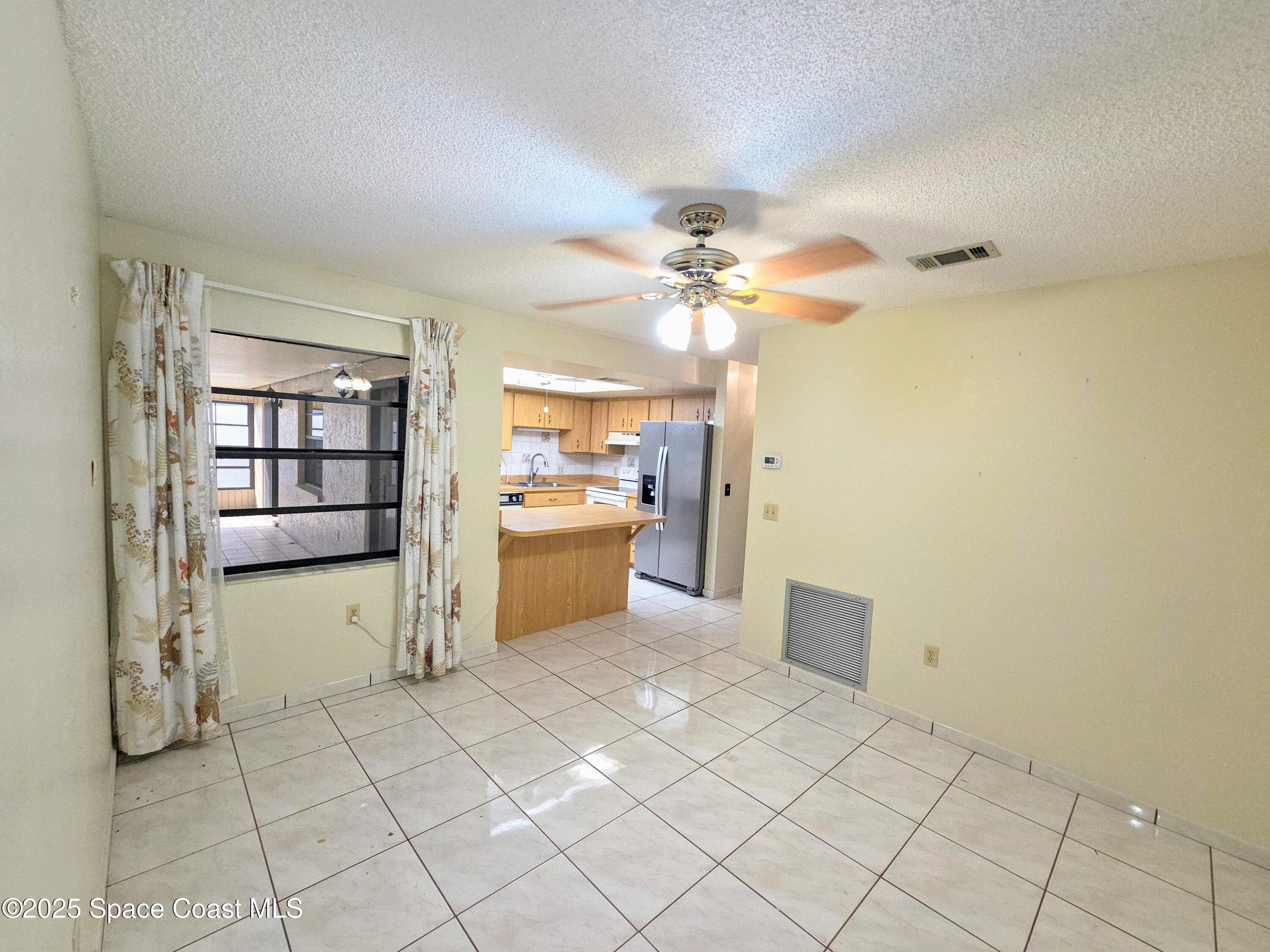 2591 Fulton Court Melbourne, FL 32935 - Photo 15 of 28 a view of a kitchen with a sink dishwasher and a refrigerator