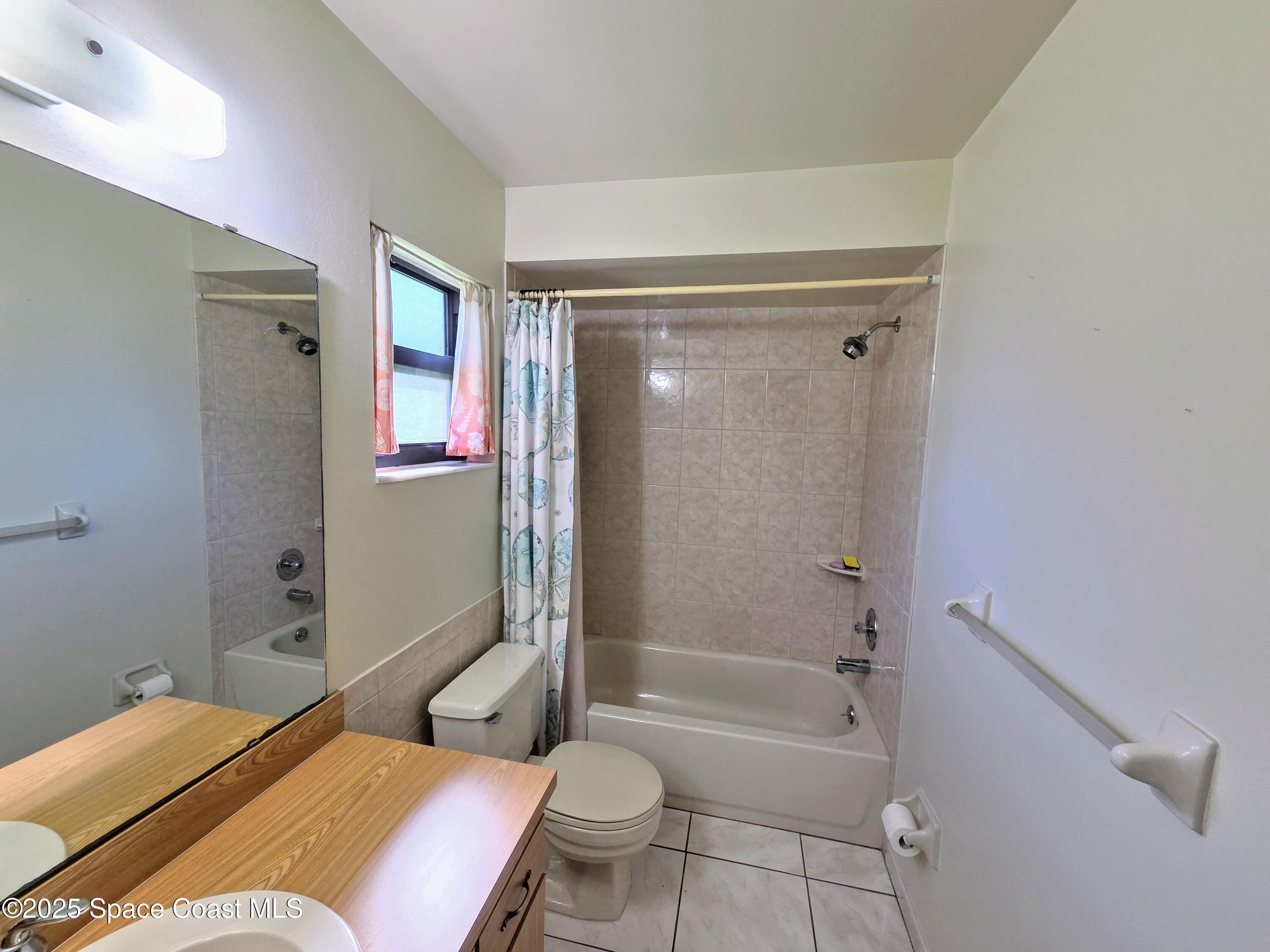 2591 Fulton Court Melbourne, FL 32935 - Photo 16 of 28 a bathroom with a sink toilet and shower