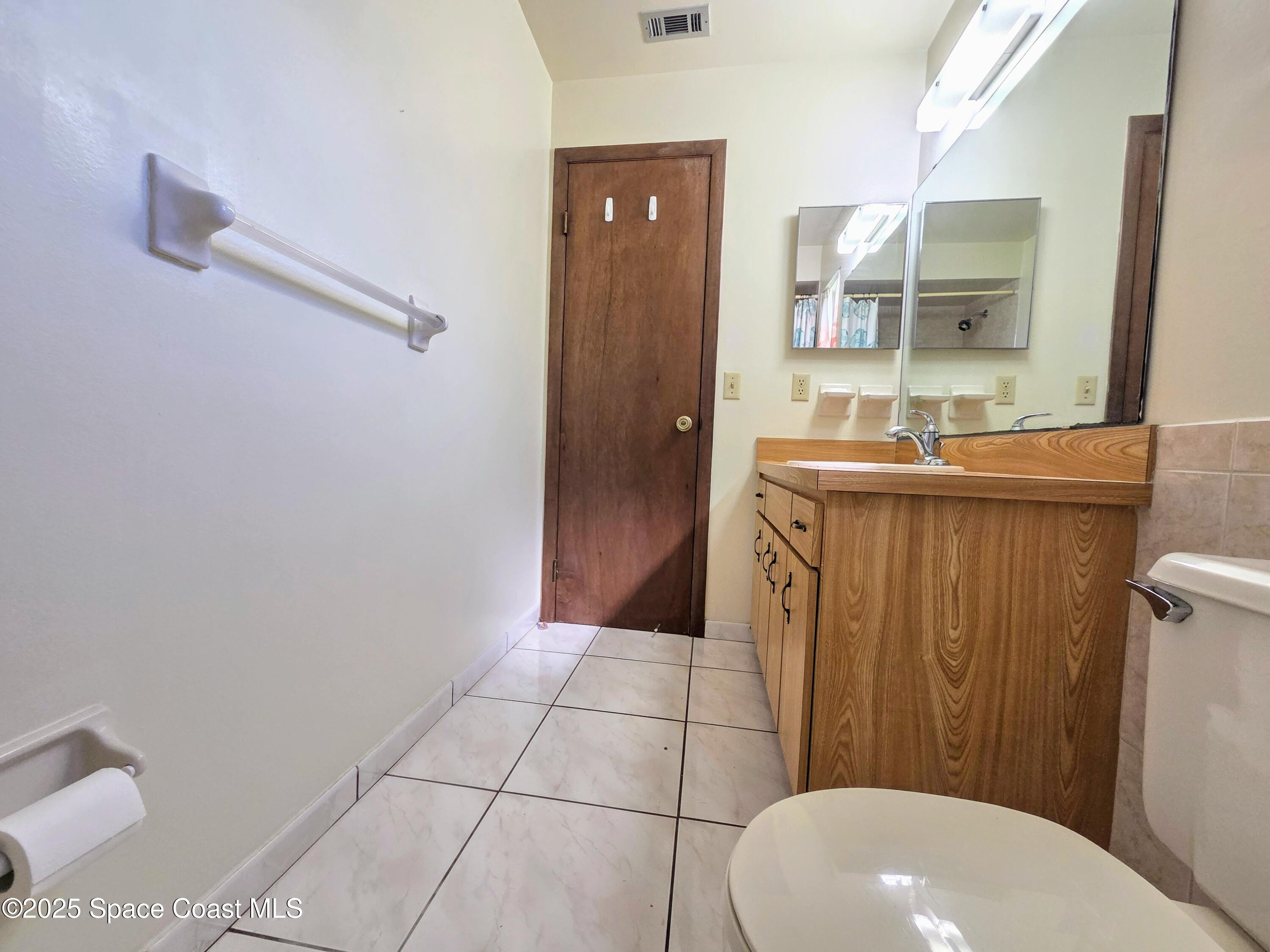 2591 Fulton Court Melbourne, FL 32935 - Photo 17 of 28 a bathroom with a sink a toilet and shower