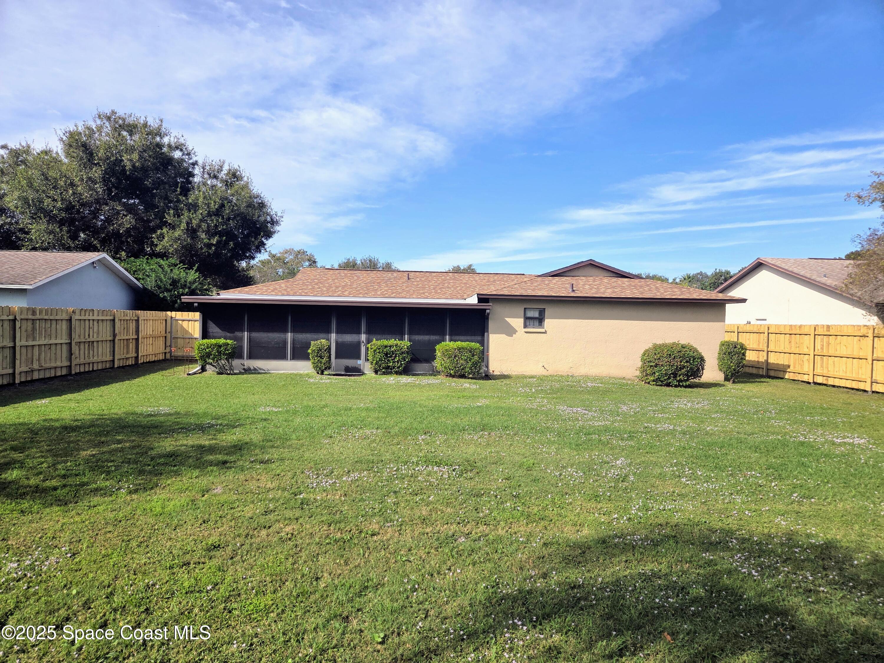 2591 Fulton Court Melbourne, FL 32935 - Photo 23 of 28 a front view of a house with a yard and garage