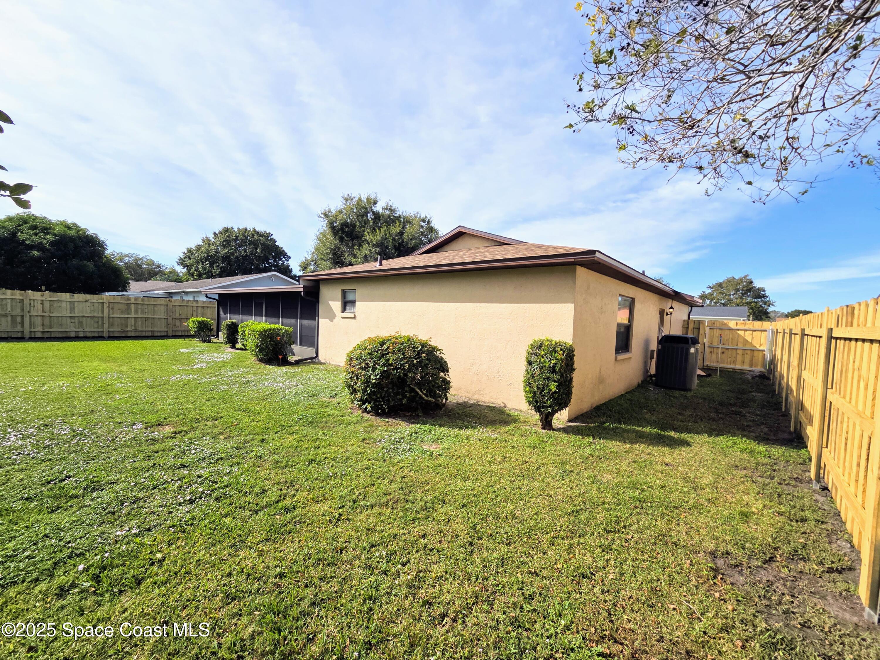 2591 Fulton Court Melbourne, FL 32935 - Photo 26 of 28 a view of a house with backyard and garden