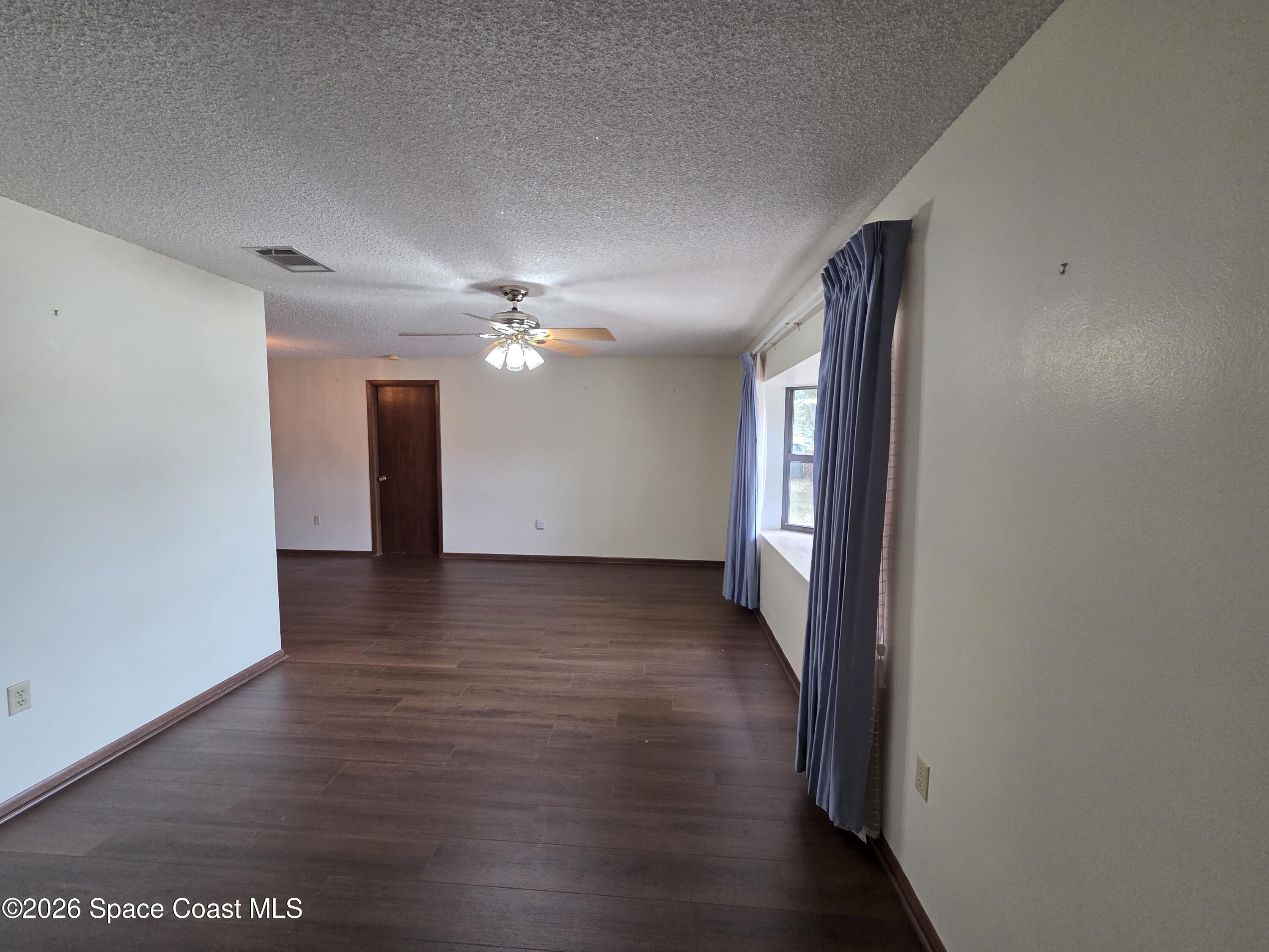 2591 Fulton Court Melbourne, FL 32935 - Photo 4 of 28 a view of a hallway with wooden floor