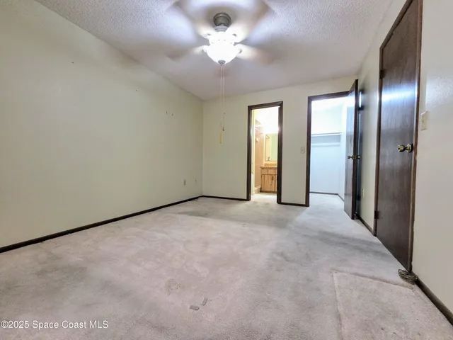 a bathroom with a granite countertop toilet sink and mirror