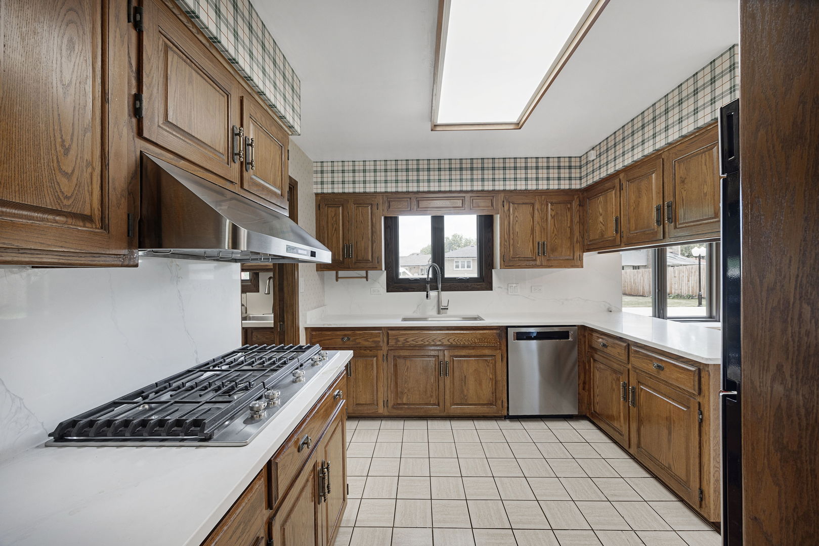 6723 Kingswood Road Willowbrook, IL 60527 - Photo 12 of 51 a kitchen with stainless steel appliances granite countertop a sink a stove and cabinets
