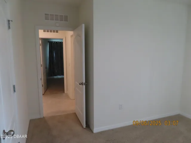 a view of a hallway with an empty room
