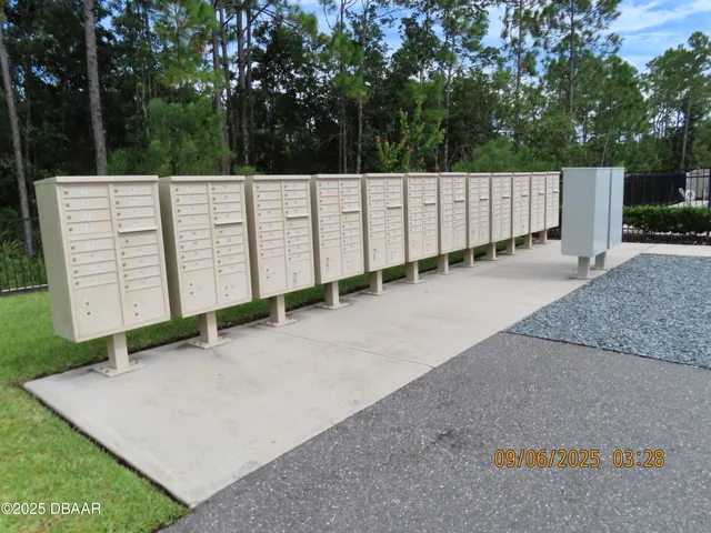 a front view of a building with trees