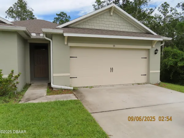 a front view of a house with garage
