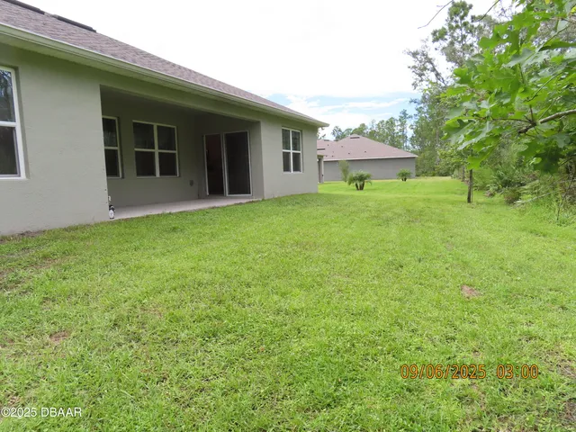 a view of a house with backyard and garden
