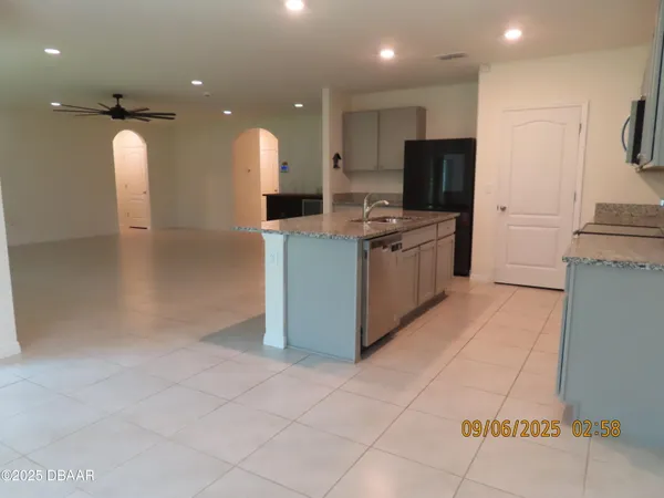 a kitchen with stainless steel appliances granite countertop a refrigerator and a stove