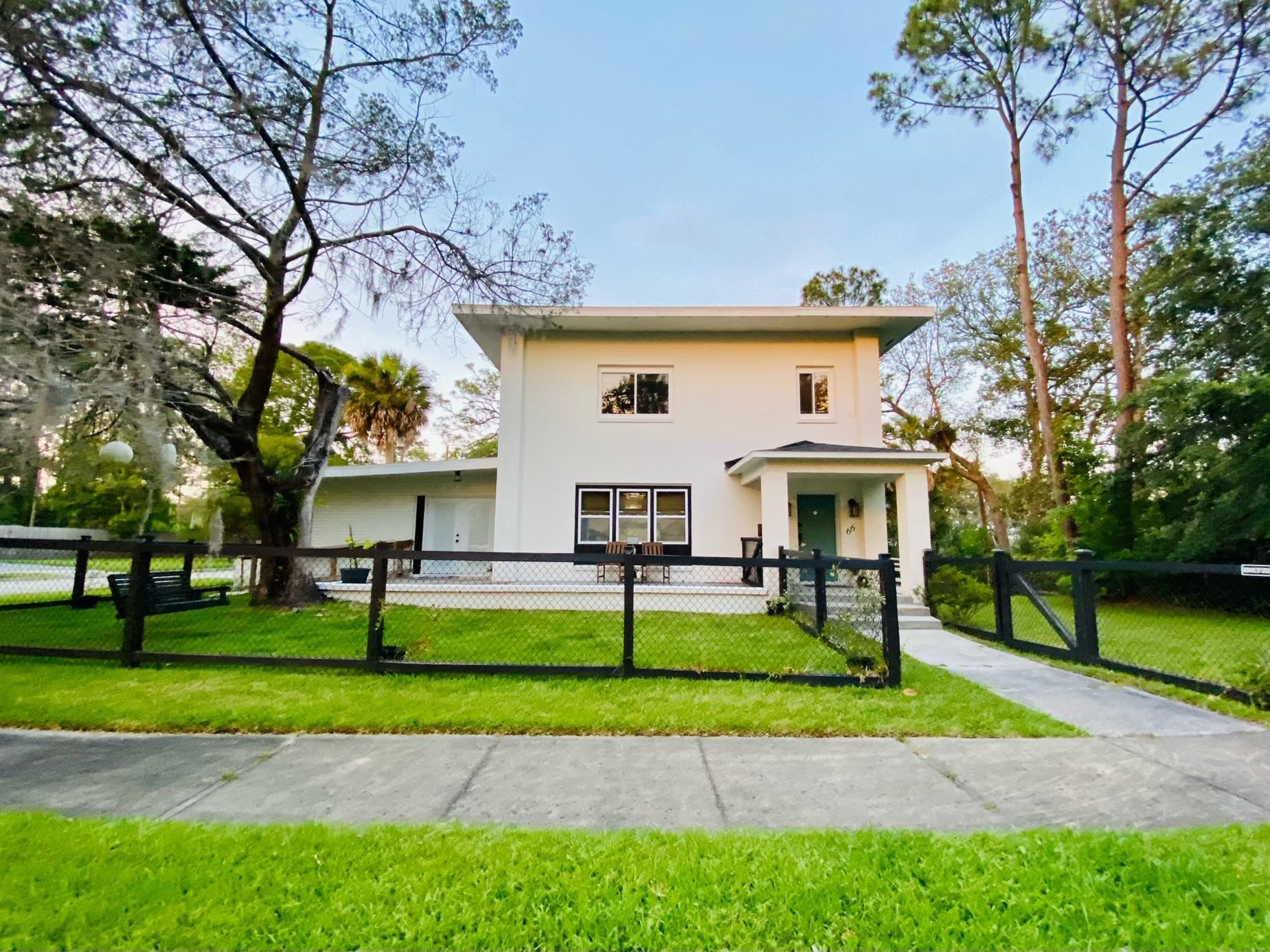 a view of a house with a yard and tree s