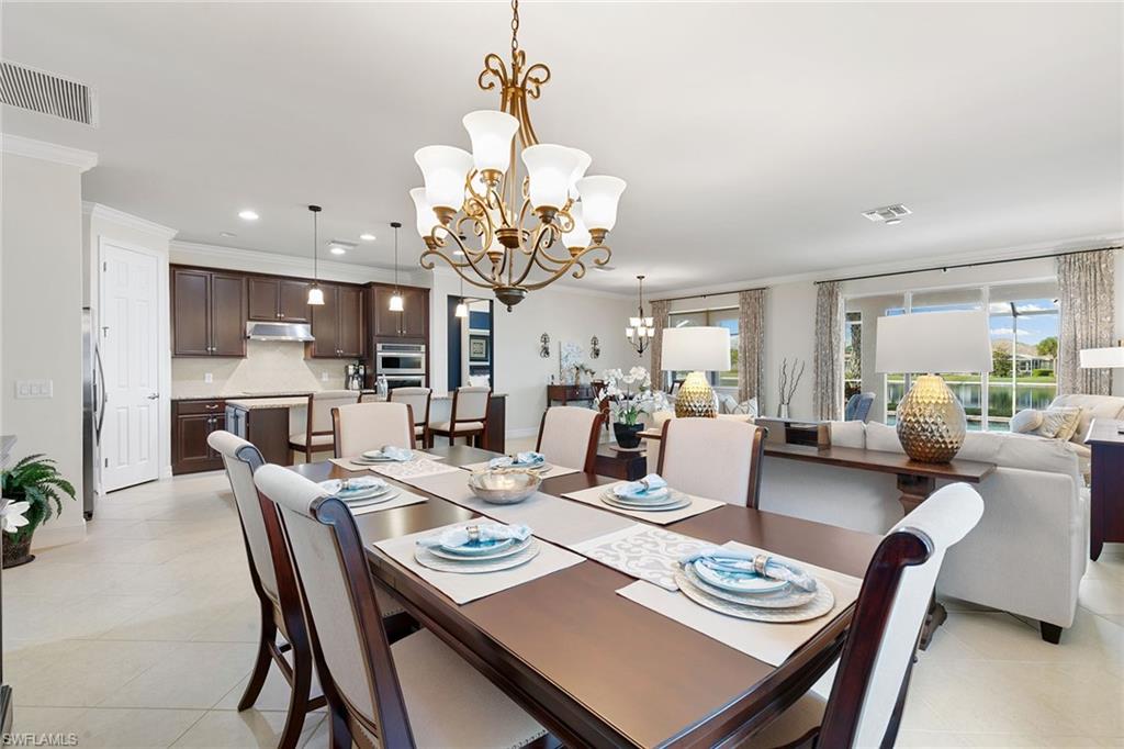 8407 Benelli Court Naples, FL 34114 - Photo 11 of 50 a view of a dining room and livingroom view kitchen with granite countertop a dining table and chairs