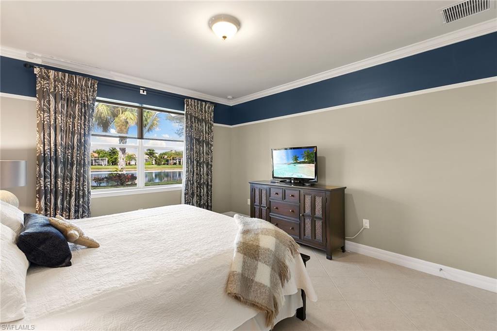 8407 Benelli Court Naples, FL 34114 - Photo 18 of 50 a bedroom with a bed and a window