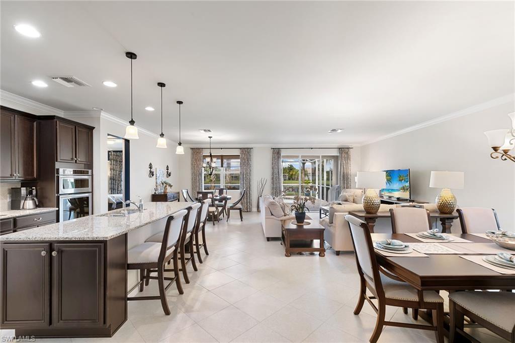 8407 Benelli Court Naples, FL 34114 - Photo 2 of 50 a large kitchen with a table and chairs