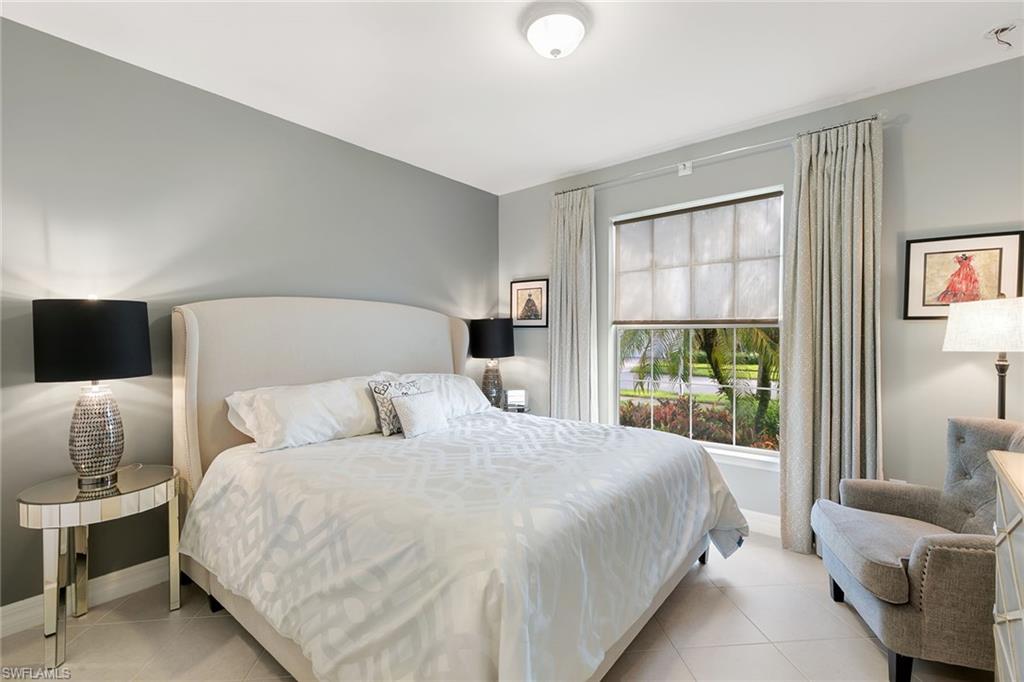 8407 Benelli Court Naples, FL 34114 - Photo 21 of 50 a bedroom with a bed and a couch