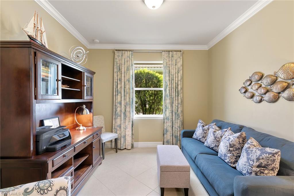 8407 Benelli Court Naples, FL 34114 - Photo 24 of 50 a living room with furniture fireplace and a window