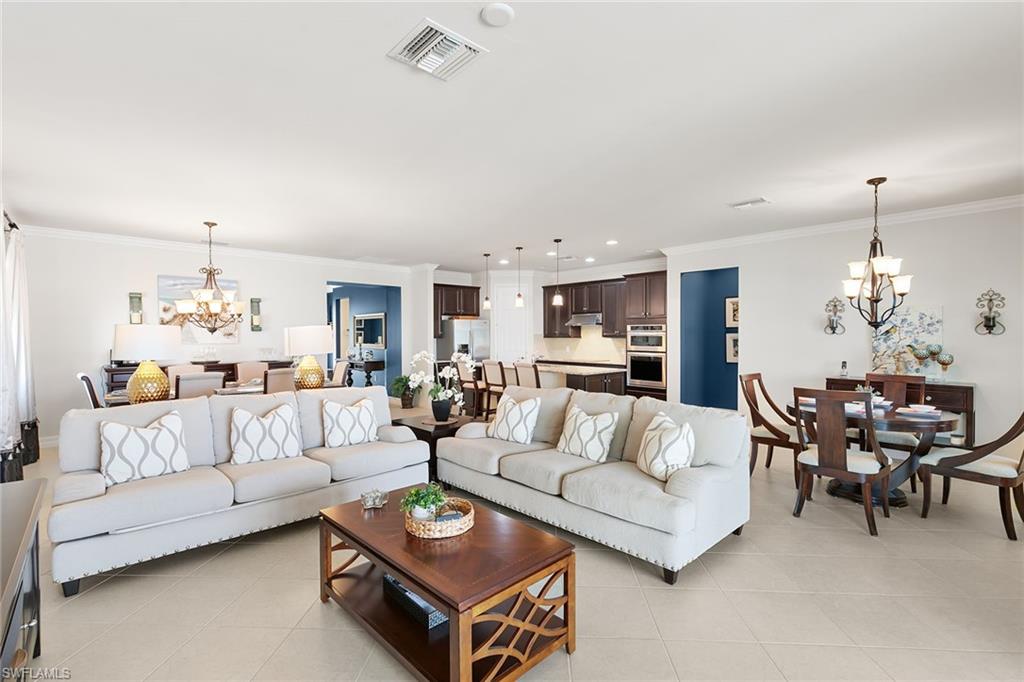 8407 Benelli Court Naples, FL 34114 - Photo 5 of 50 a living room with furniture dining area and a chandelier