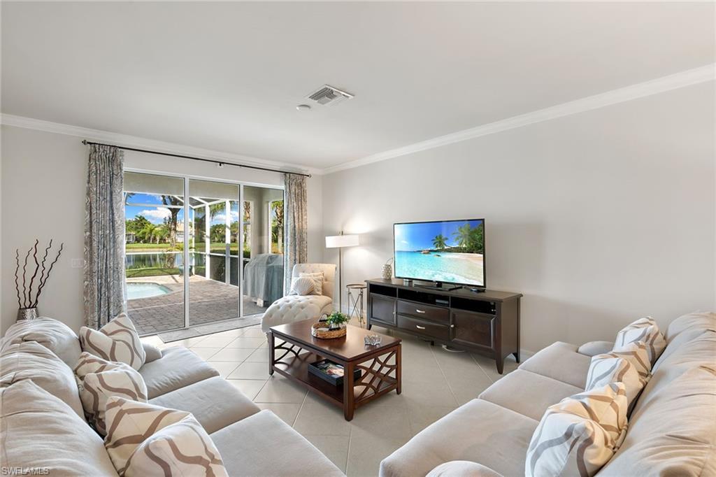 8407 Benelli Court Naples, FL 34114 - Photo 7 of 50 a living room with furniture flat screen tv and a large window