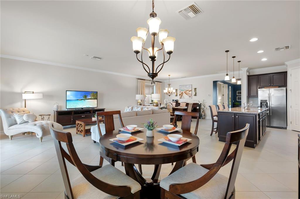 8407 Benelli Court Naples, FL 34114 - Photo 8 of 50 a view of a dining room with furniture and chandelier