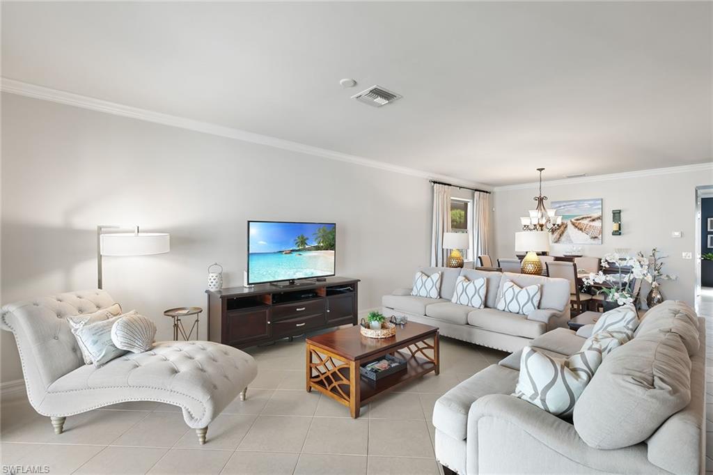 8407 Benelli Court Naples, FL 34114 - Photo 9 of 50 a living room with furniture or couch and a flat screen tv
