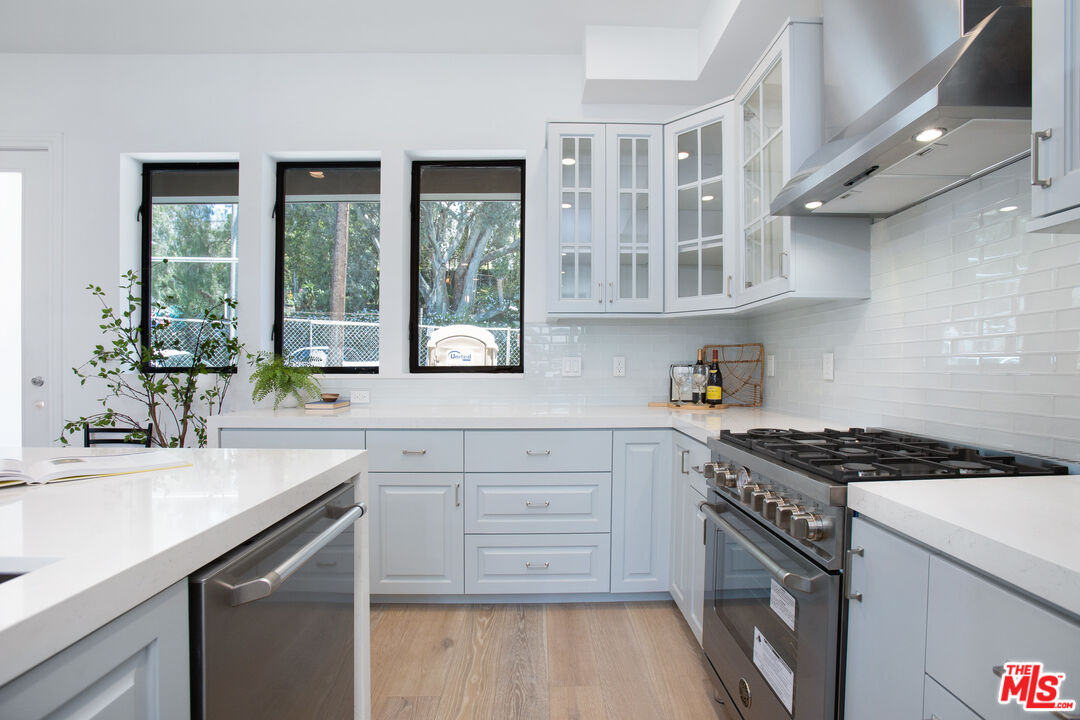 855 Merwin Street Los Angeles, CA 90026 - Photo 3 of 12 a kitchen with stainless steel appliances granite countertop a stove and a sink