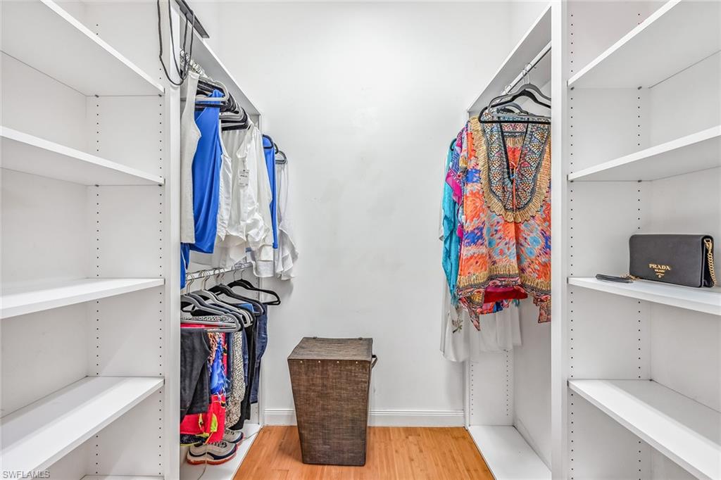 2881 Hatteras Way Naples, FL 34119 - Photo 17 of 32 a view of walk in closet with clothes and shoes