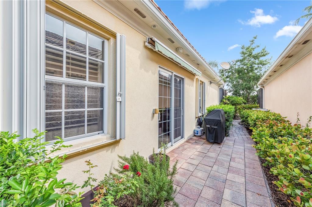 2881 Hatteras Way Naples, FL 34119 - Photo 27 of 32 a house with a flower garden