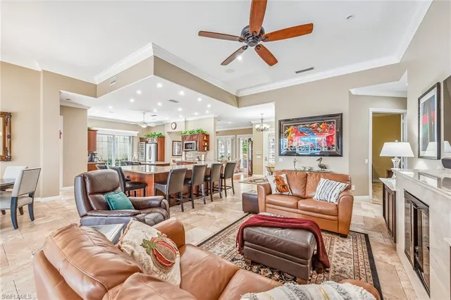 a living room with furniture ceiling fan and a rug