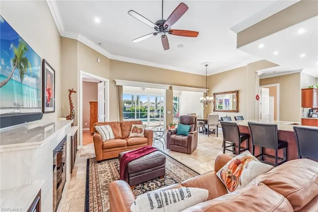 a living room with furniture a flat screen tv and a large window